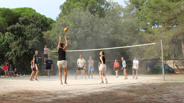Students play Volleyball at summer camp 