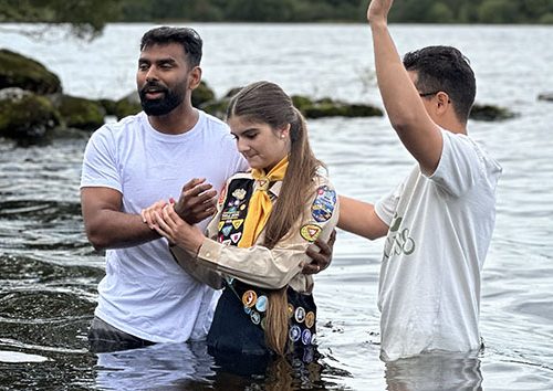 Girl getting baptised at a lake, Irish Mission summer camp
