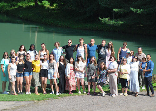Lithuanian young people by a turquoise body of water, group picture. July 2025