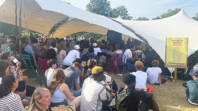 People sitting outside the crowded spoken word stage, BCF 2025