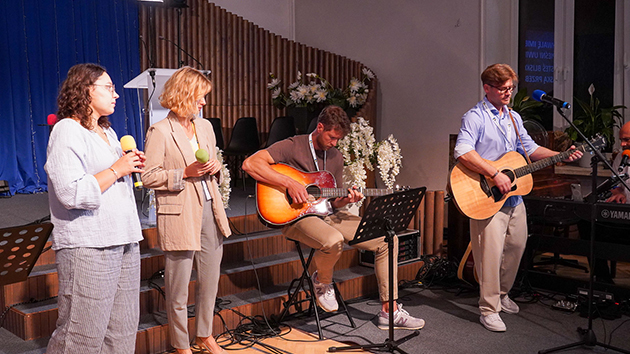 Worship team leads singing during the conference programme