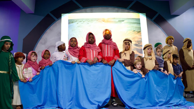 A group of children bring energy and teamwork to their performance, depicting scenes from the Israelites’ journey to the Promised Land