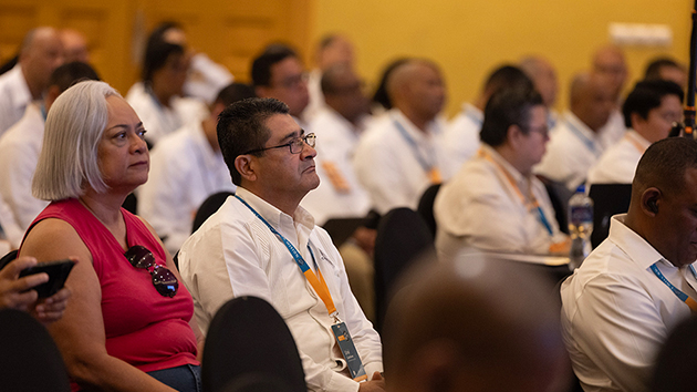 Pastor Uriel Castellanos (right), president of the Soconusco Mexican Conference, listens during the devotional service alongside his wife, Mary Torres (left)
