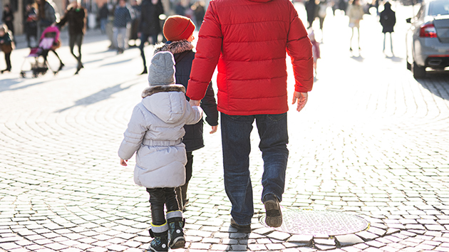 Father walking with his two children