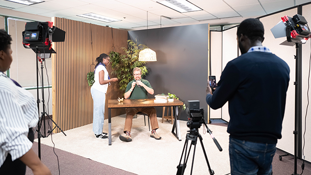 A content creator uses one of the summit’s 25 dedicated sets to produce digital content for mission
