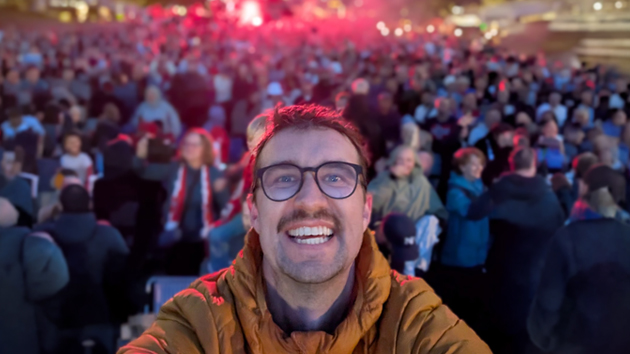 Simen Trolsrud takes a selfie as hundreds gather behind him to watch Norway face Brazil, united for one unforgettable night