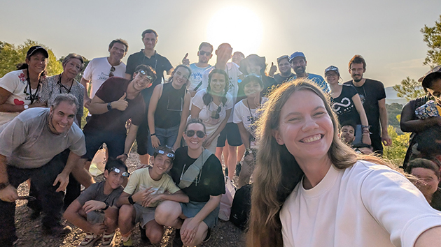 Participants gather for a group photograph on a hillside near Sagunto Adventist Campus ahead of the total solar eclipse on 12 August