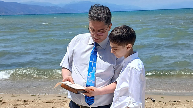 Pastor Gentian Thomollari with his son, Mateo, moments before baptising him in Pogradec, Albania