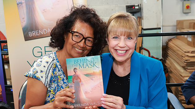 Brenda Walsh, right, meets an attendee during the book signing for Behind the Mask at the Stanborough Press Open Day